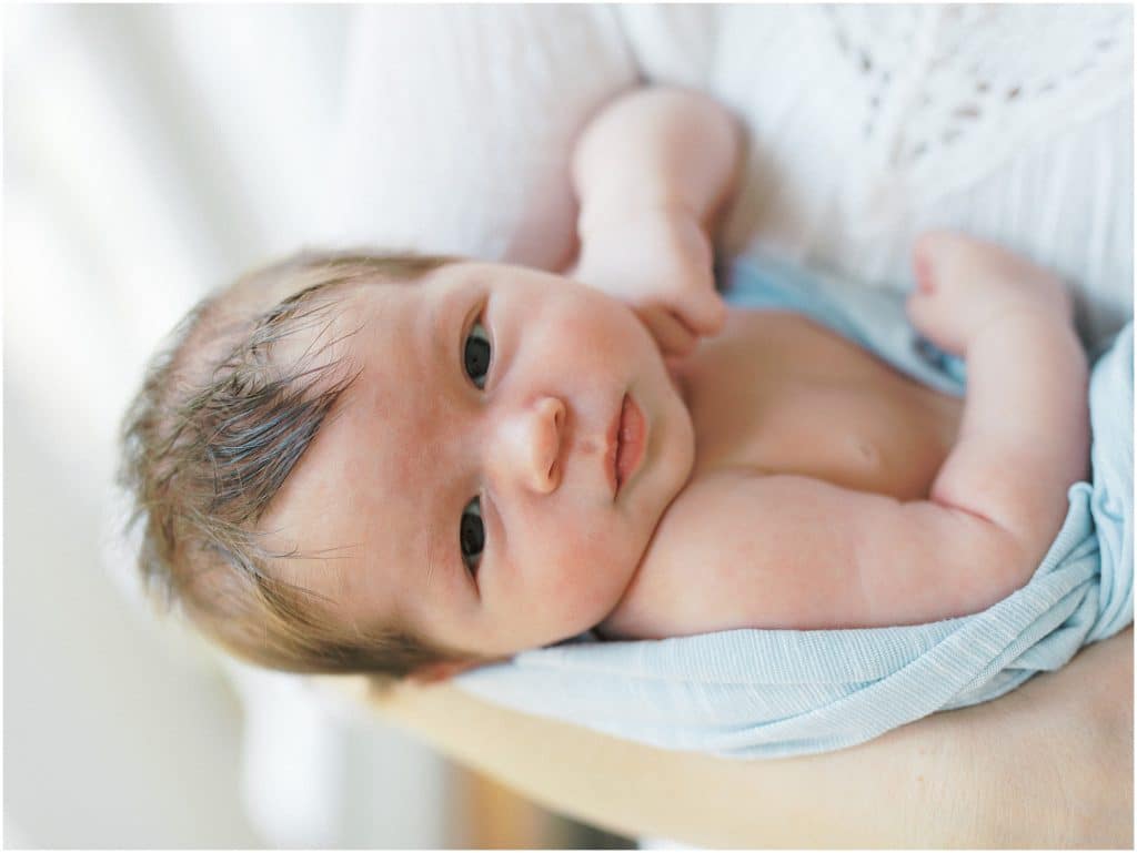 picture of newborn baby looking directly into camera