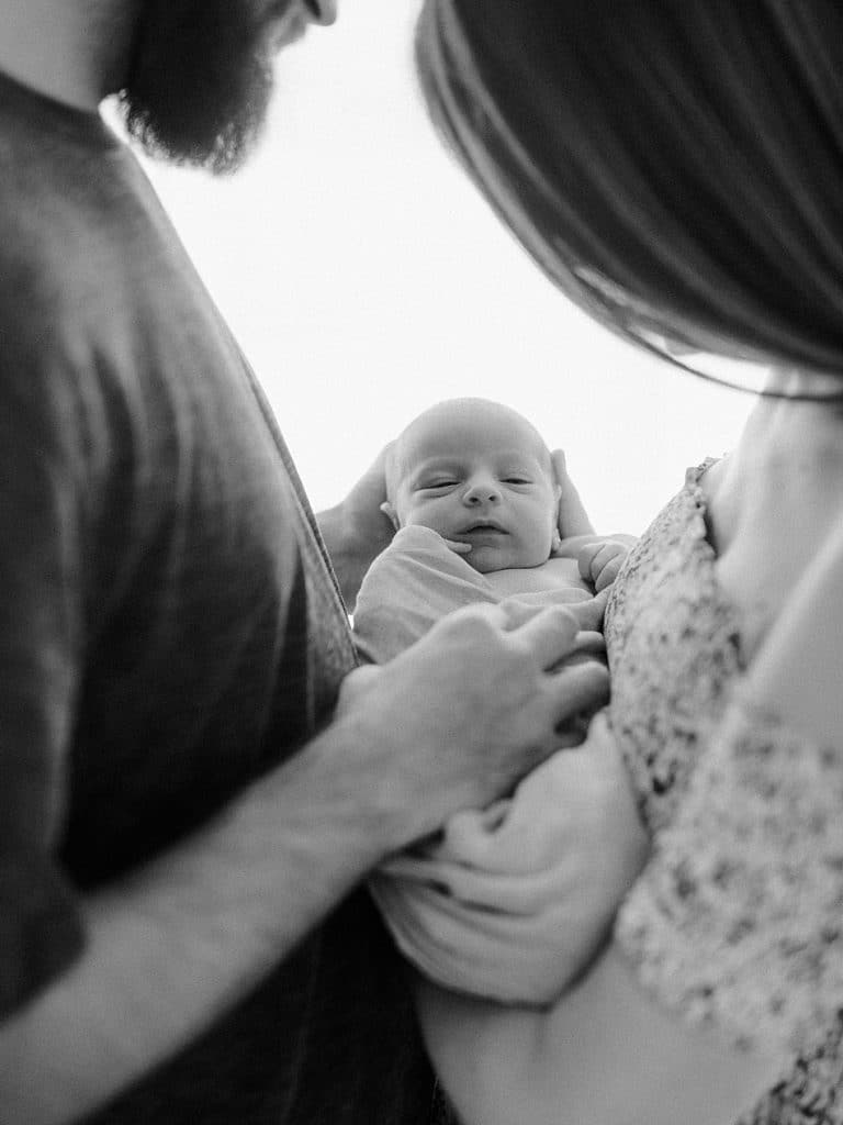 Black and White Picture of parents holding baby