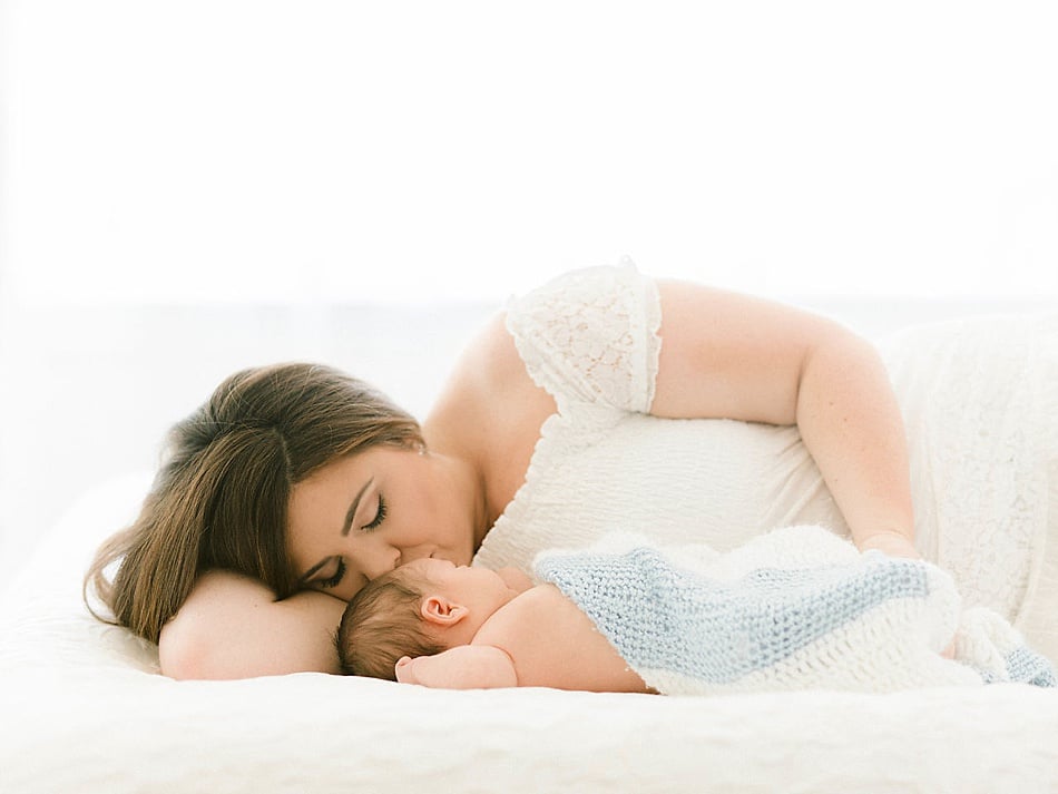 Portrait of mom snuggling baby boy