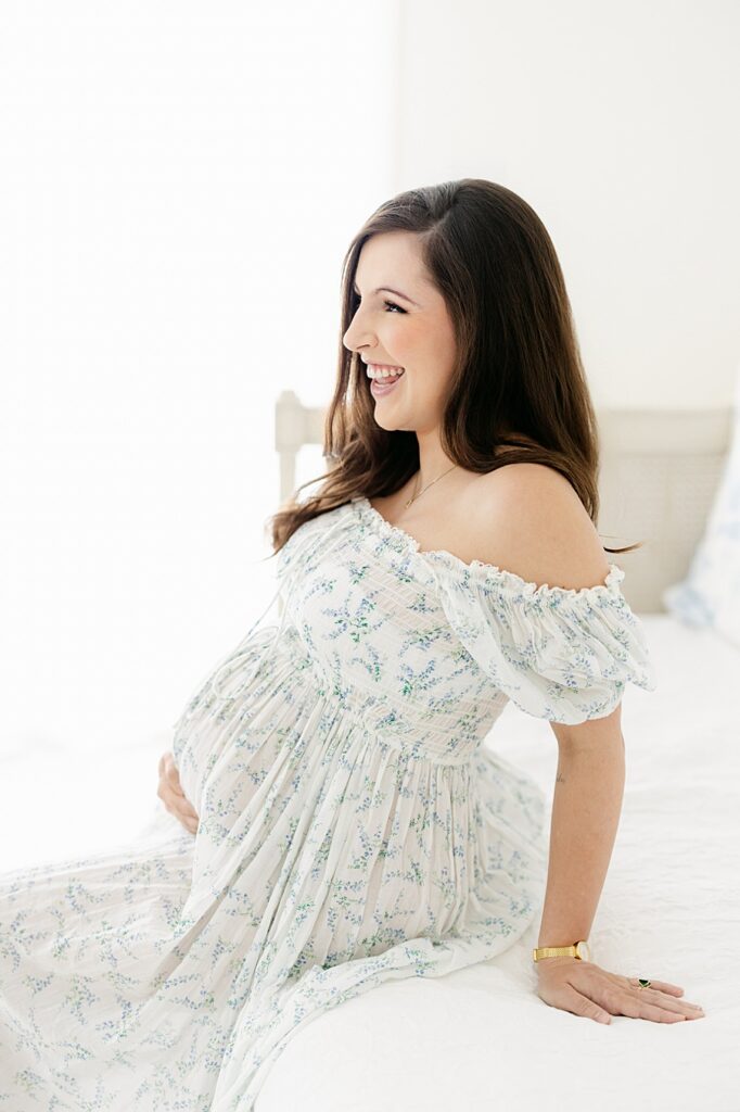 in studio maternity session with mom wearing Doen dress.