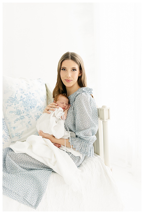 Mom holding newborn baby in a Savannah Newborn Photography Studio